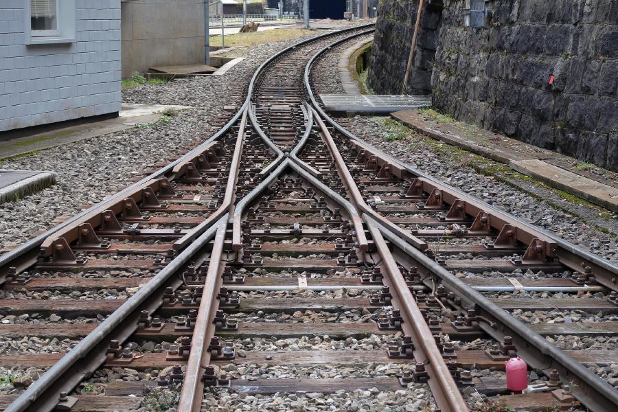 Three train tracks joining into one by a track switch
